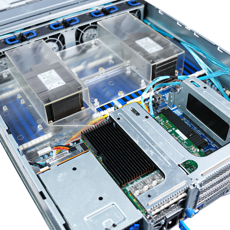 Close-up of server interior showing dual CPU heatsinks under clear air shrouds, cooling fans, and a heatsink-covered network card in a PCIe riser.