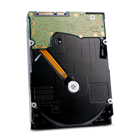Angled view of the underside of a 3.5-inch hard disk drive, showing the green circuit board, orange flex cable, and black base casting.