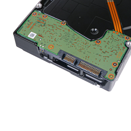 Underside of a 3.5-inch hard disk drive, showing the green circuit board and SATA data and power connectors.
