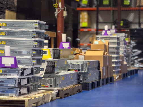 Pallets of enterprise servers staged in the ServerPartDeals warehouse