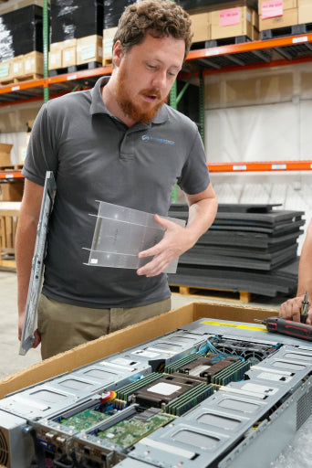 A technician removing a drive tray from a server chassis