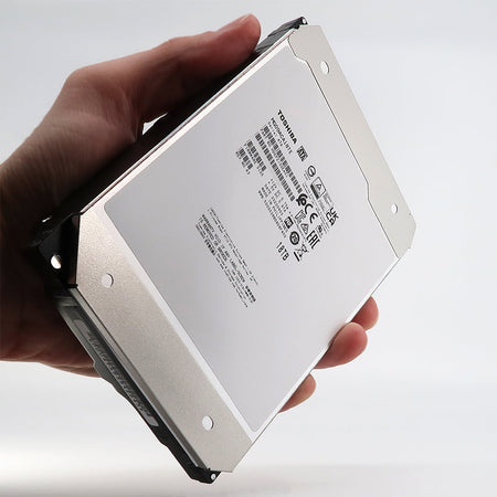 Toshiba MG09 MG09ACA18TE 18TB 7.2K RPM SATA 6Gb/s 512e 3.5in Hard Drive - Handheld view